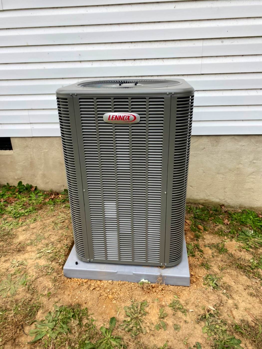Residential AC condenser on a new pad