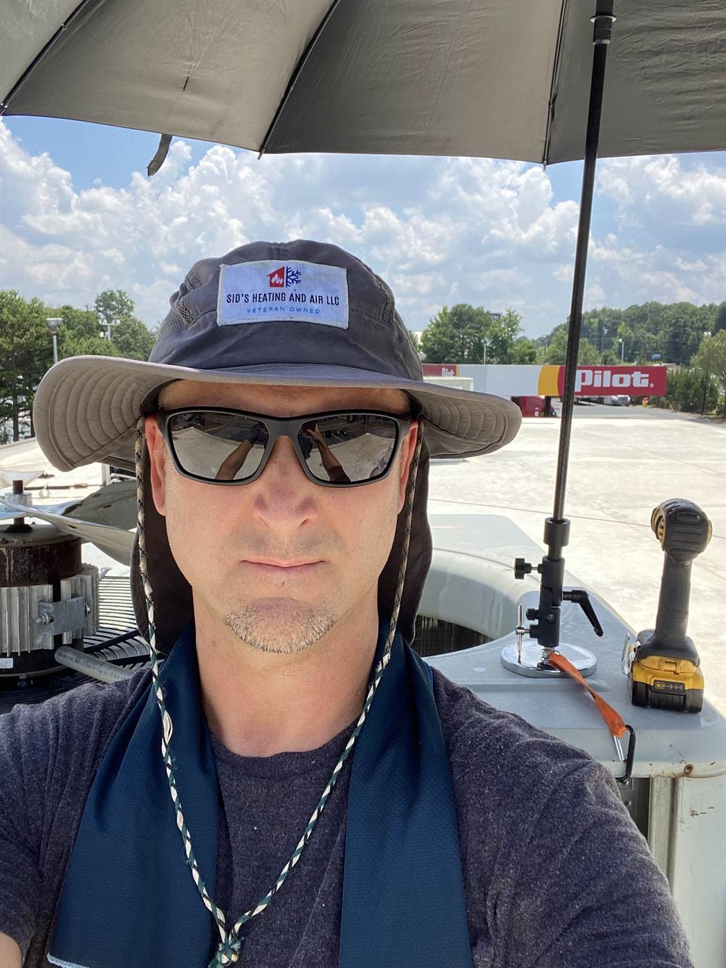 Sid's Heating and Air technician on a commercial rooftop job