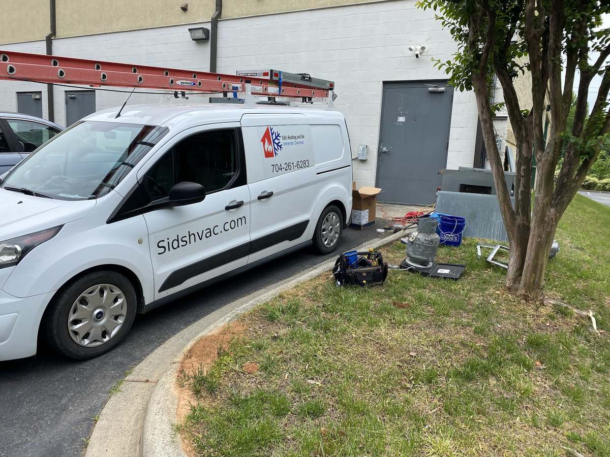 Sid's Heating and Air van parked at a residential service call