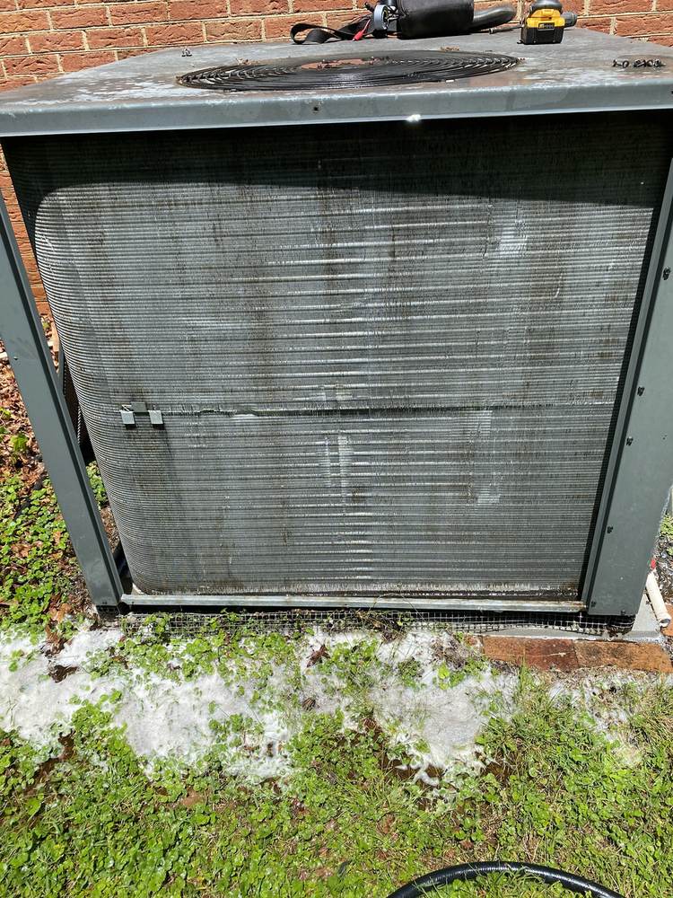 Heavily fouled condenser coil photographed before cleaning