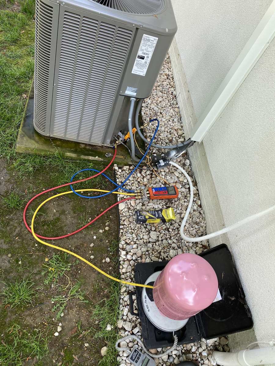 AC condenser on manifold gauges during a refrigerant charge check