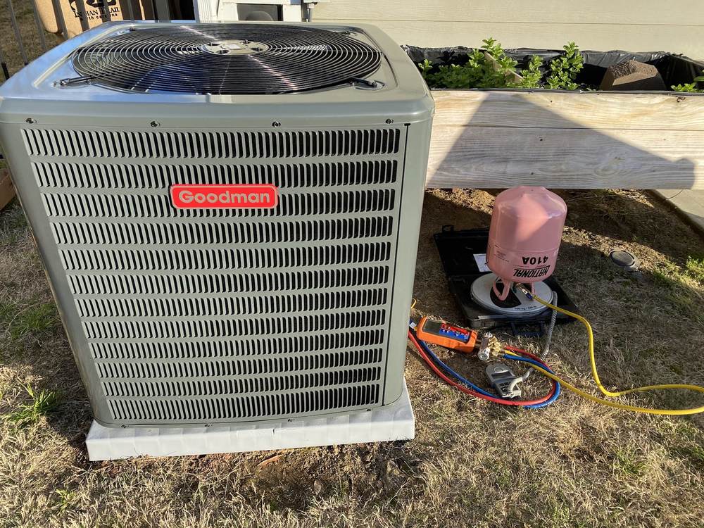 Residential condenser connected to manifold gauges
