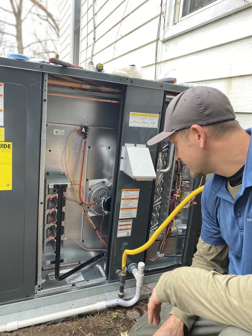 Technician working inside a packaged rooftop unit