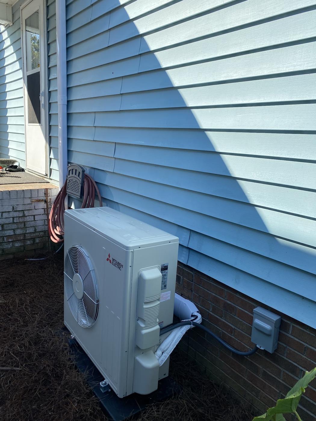Ductless mini-split outdoor unit installed at a residence