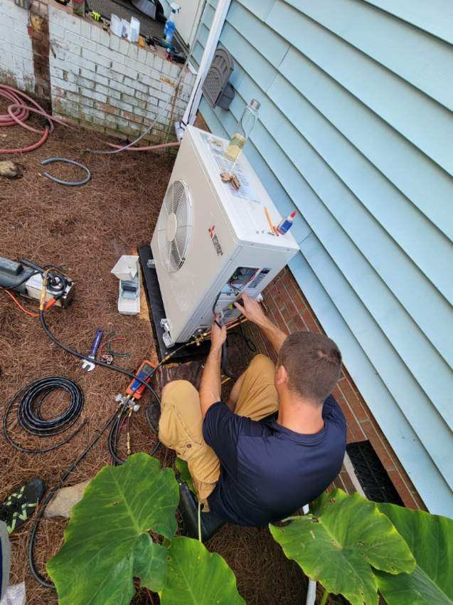 Technician servicing an outdoor condensing unit